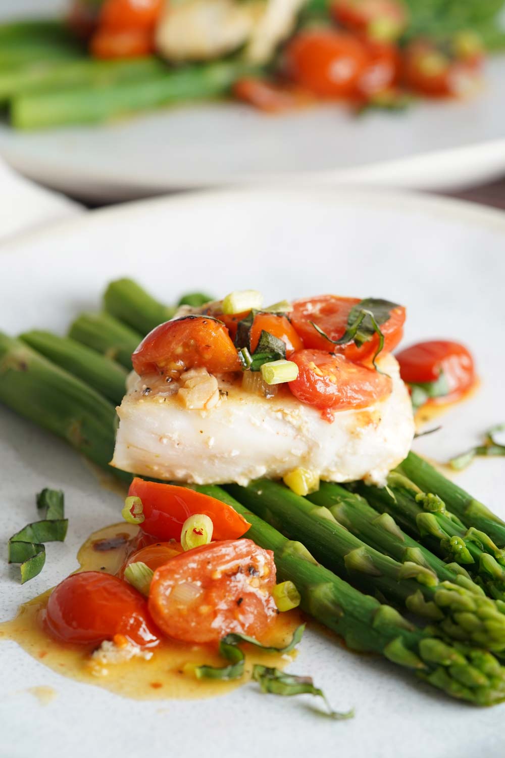 Cod and asparagus in tomato lemon butter sauce