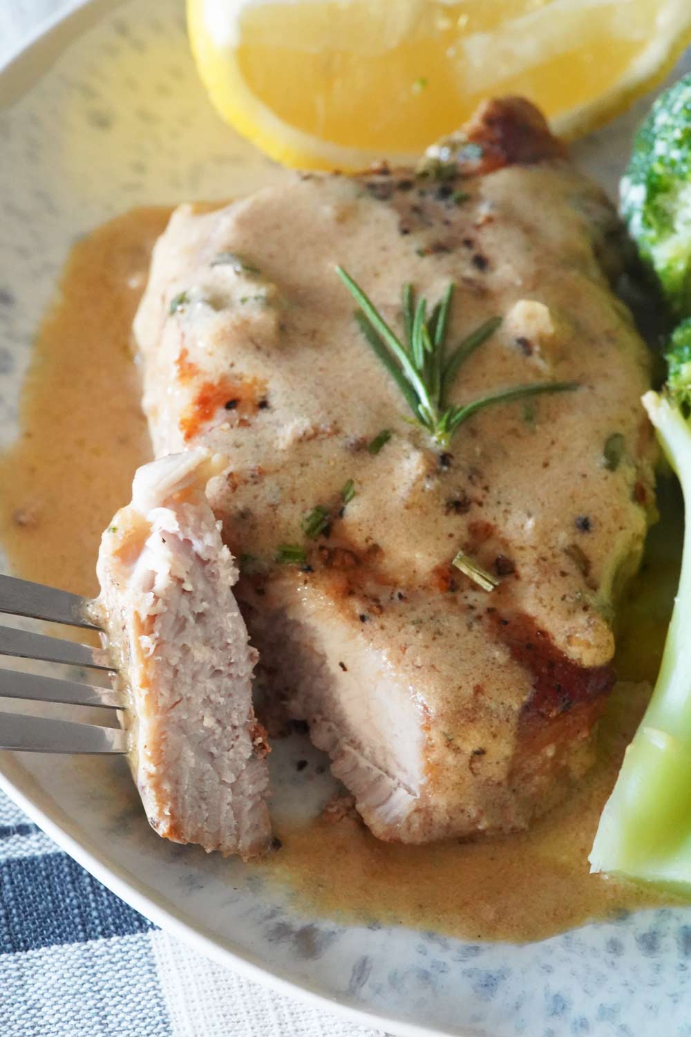 A Creamy garlic pork chop on a plate