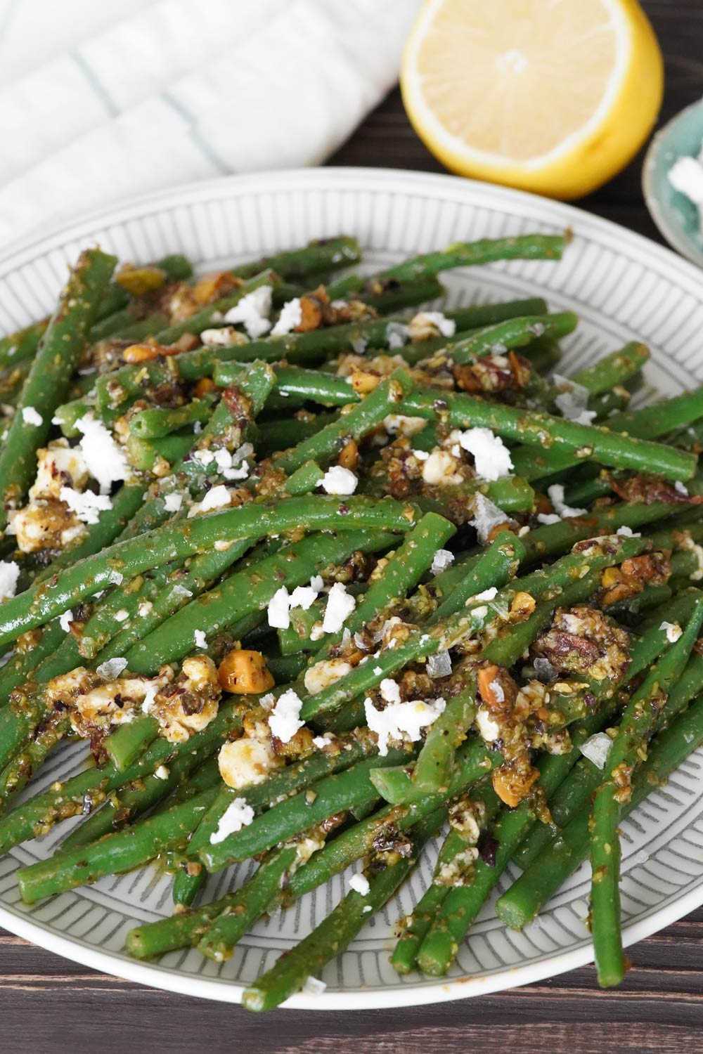 green beans on a plate with pesto and feta, low carb green beans with pesto and feta