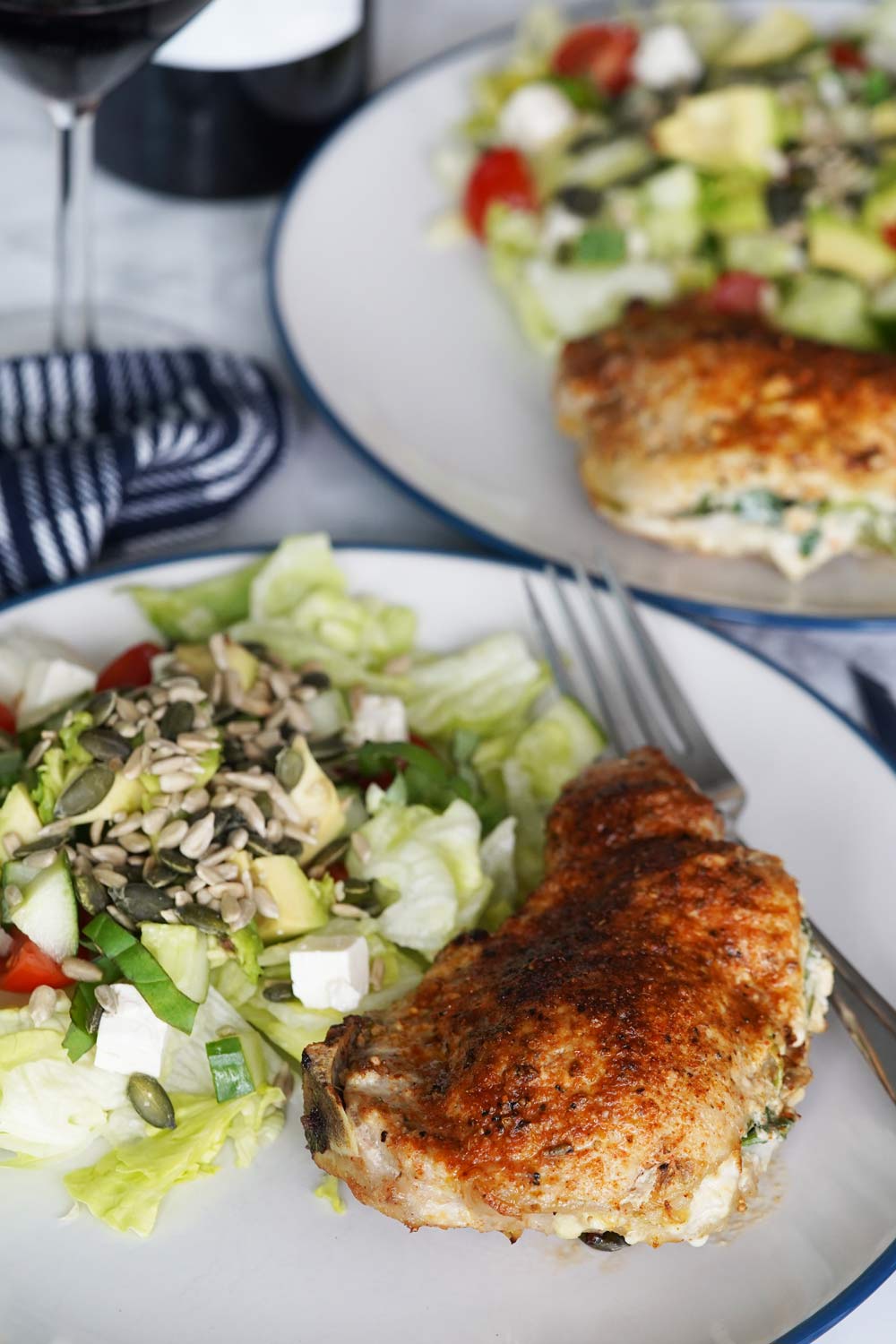 Stuffed pork chops on a plate with salad